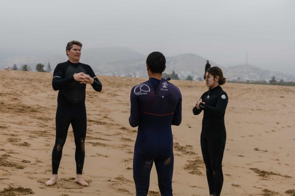 A small group of surfers preparing for a surf session in Morocco